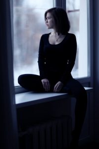 young woman gazing out the window